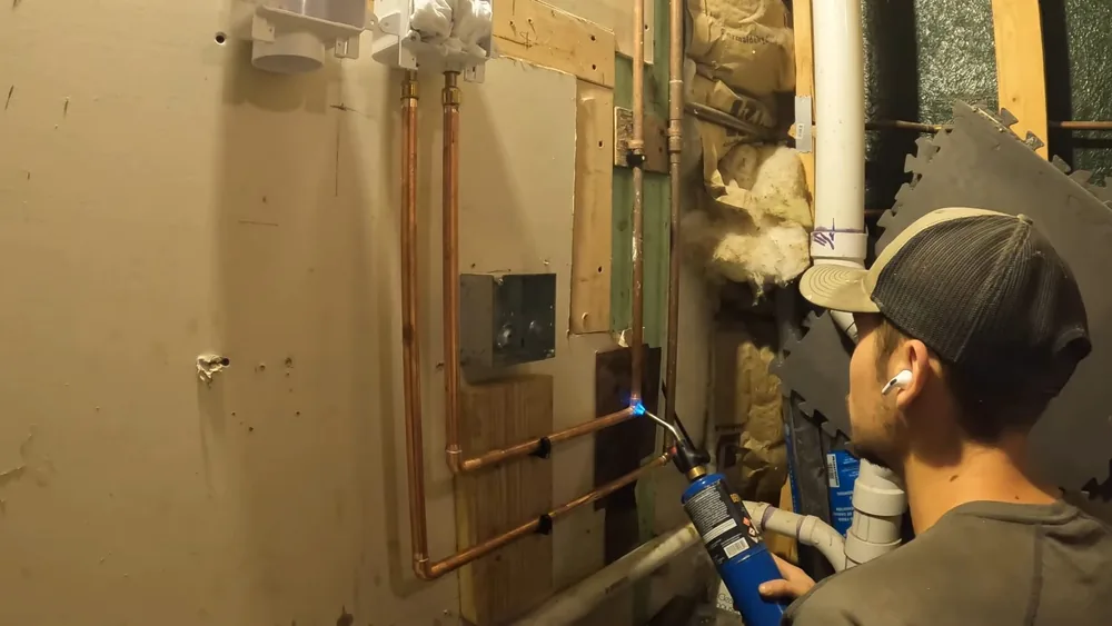 Exposed interior plumbing and pipe repair area showing desert detail for residential community in Buckeye, AZ