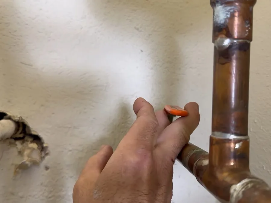 Water heater tank, piping, and service components used during water heater repair work near Buckeye, AZ